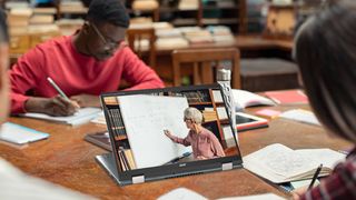 Best student discounts -Acer convertible Chromebook on a library table surrounded by students