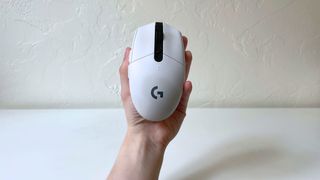 The Logitech G305 LIGHTSPEED in someone's hand with the top of the mouse visible